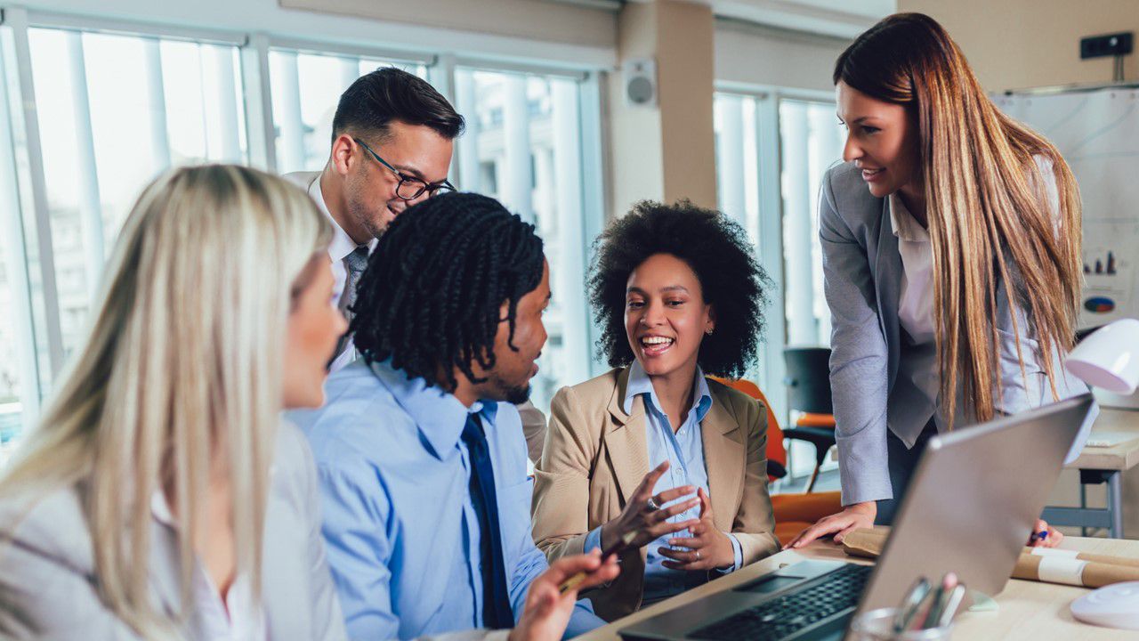 Diverse group of young workers at table